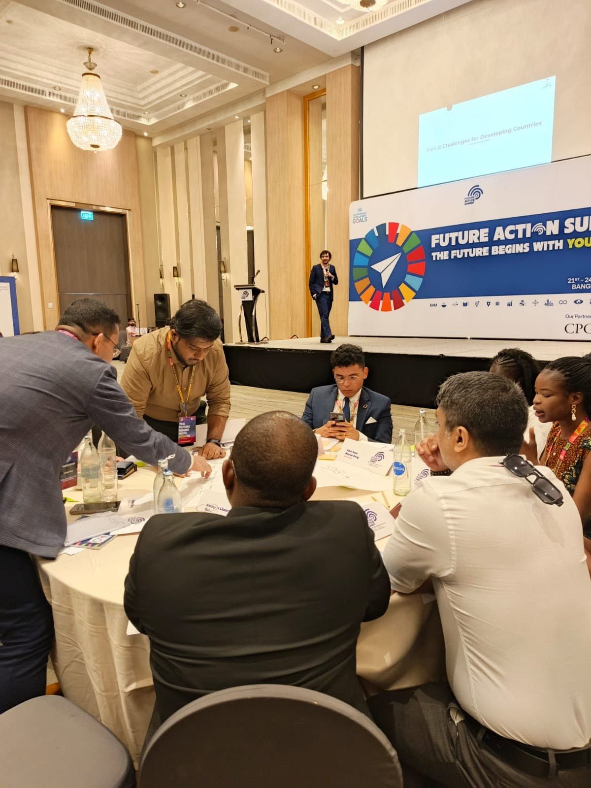 Delegates working in groups at round tables