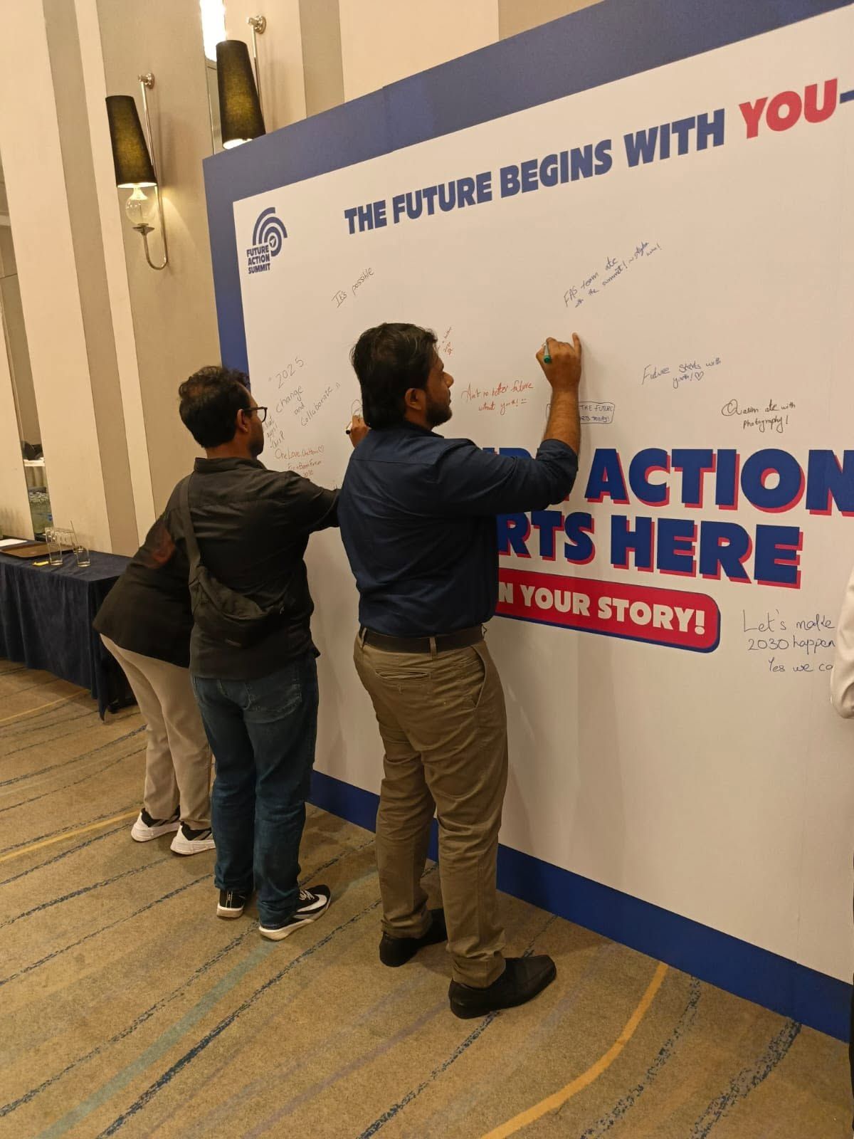 Delegates signing the summit pledge wall